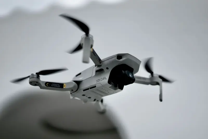 Detailed close-up image of a drone hovering in mid-air with a blurred background