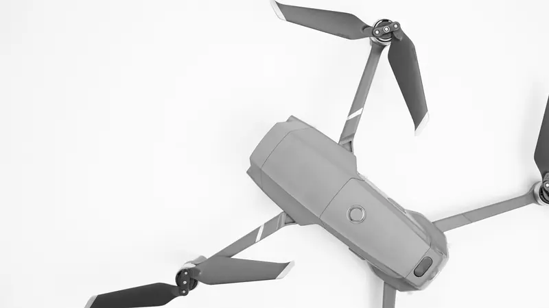 Aerial drone with propellers on a white surface, showcasing modern technology