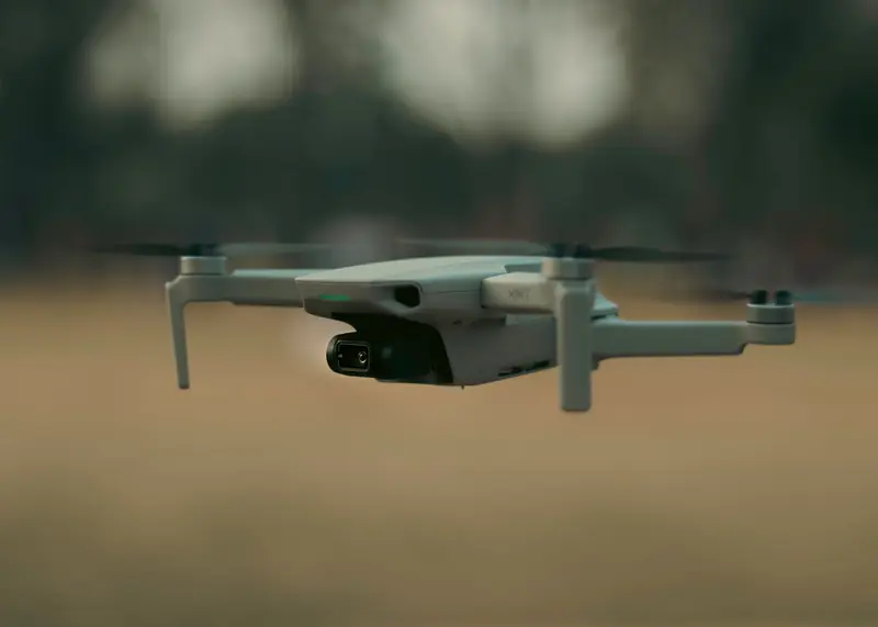 A drone flying close to the ground, ready to capture stunning aerial views outdoors