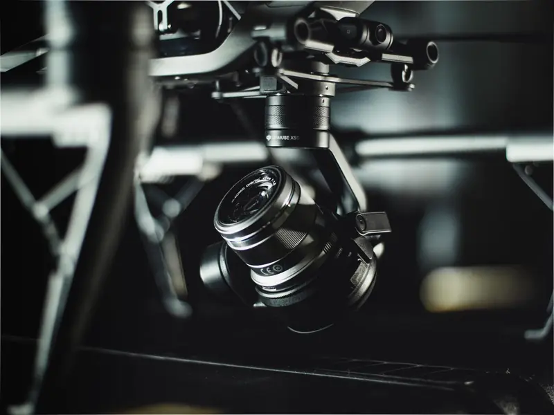 A detailed close-up shot of a camera drone with a high-tech lens