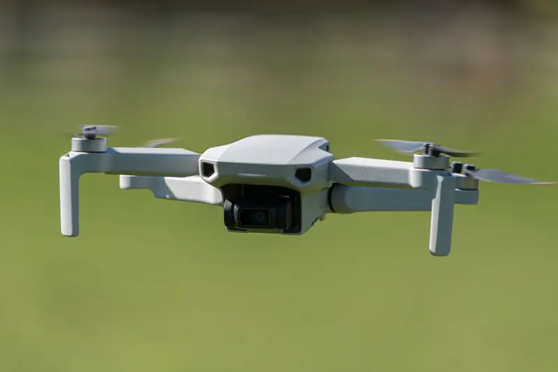 Aerial drone captured mid-flight over a lush green field in Leeds, UK