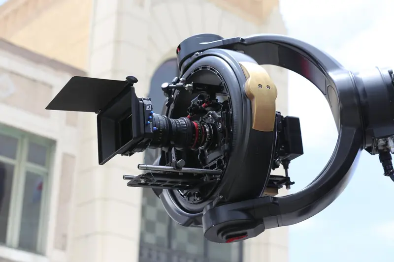 Detailed shot of a professional cinema drone camera rig with lens and gimbal outdoors