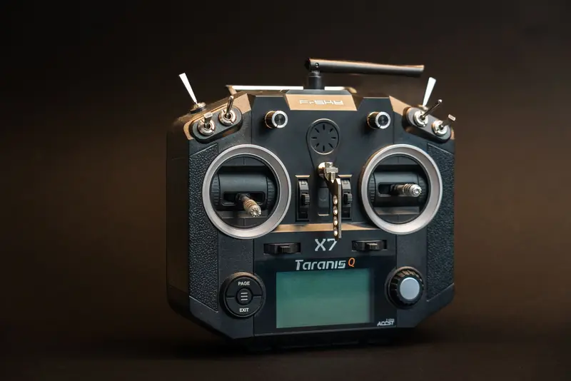 Black Taranis Q X7 drone controller with buttons and screen in a studio shot