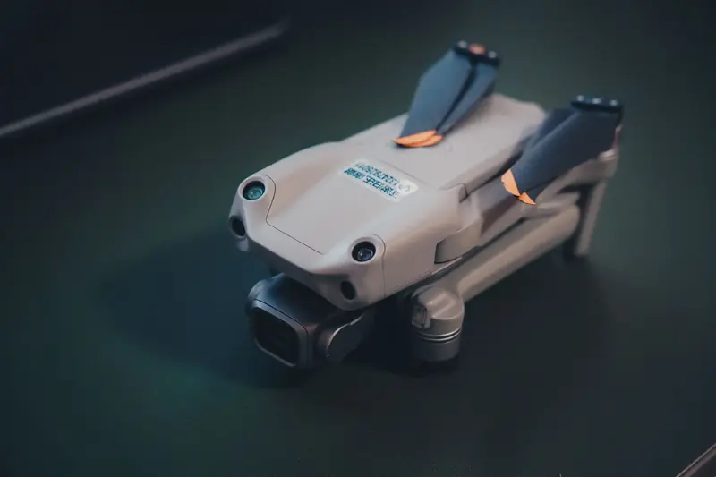 Close-up of a compact drone with folded arms on a dark surface, emphasizing modern technology